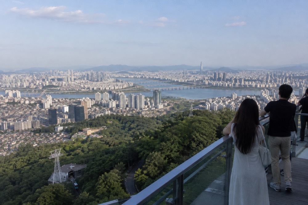 Seoul skyline spreading out beneath N Seoul Tower on a clear afternoon
