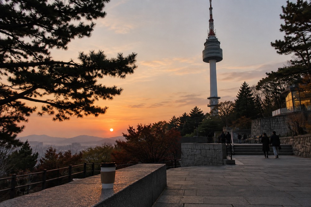 The summit plaza and terraces around the base of N Seoul Tower at dusk