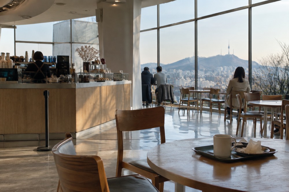 Interior of an observation deck with a cafe counter and floor-to-ceiling windows