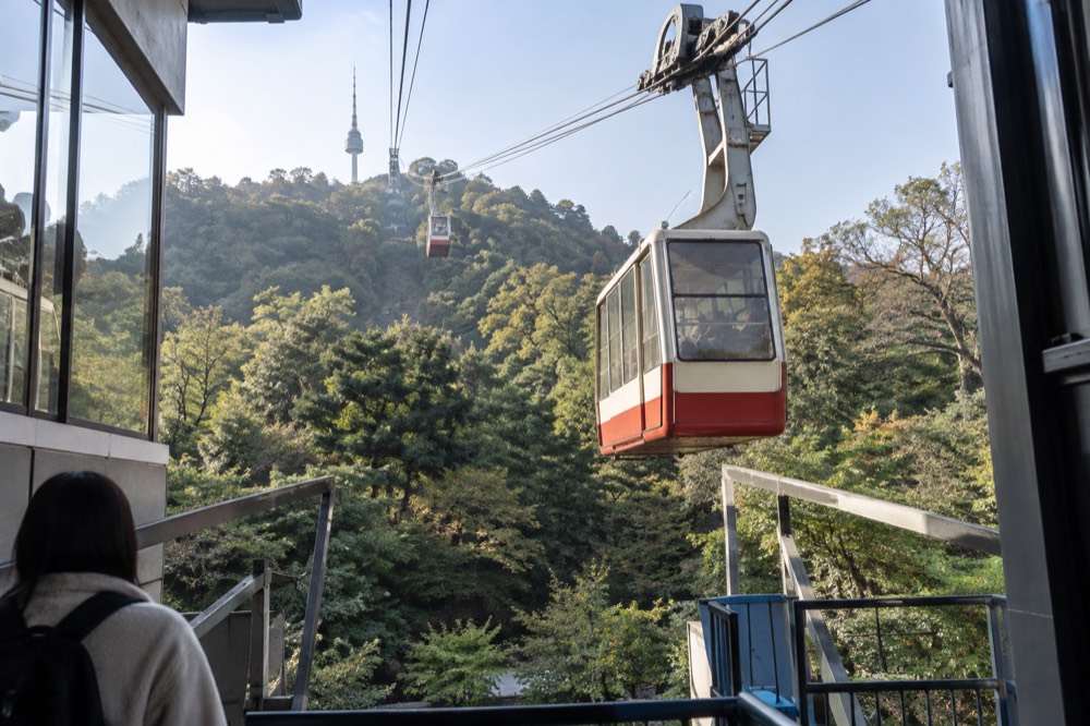 Cable car cabins travelling up the steep cable line toward the Namsan summit
